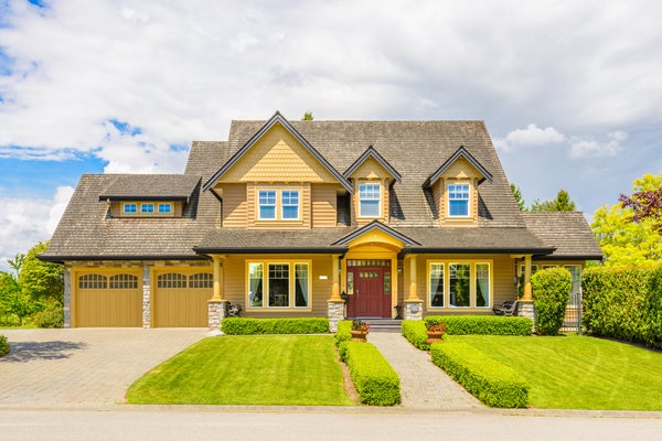 Idyllic yellow home for sale with landscaping located in the area of Kensington, Maryland