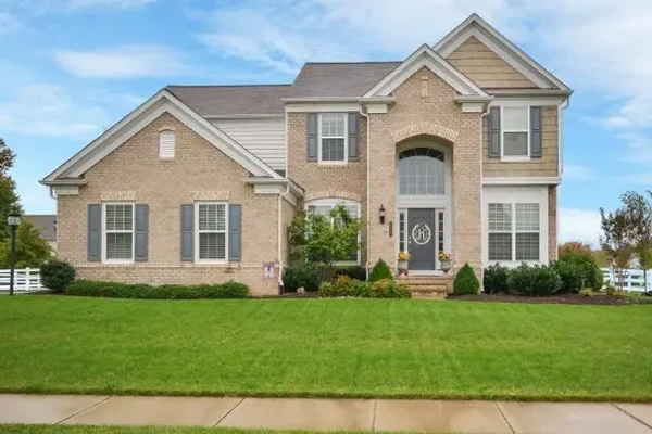 A Kingstowne, Virginia luxury home for sale with spacious, green front lawn