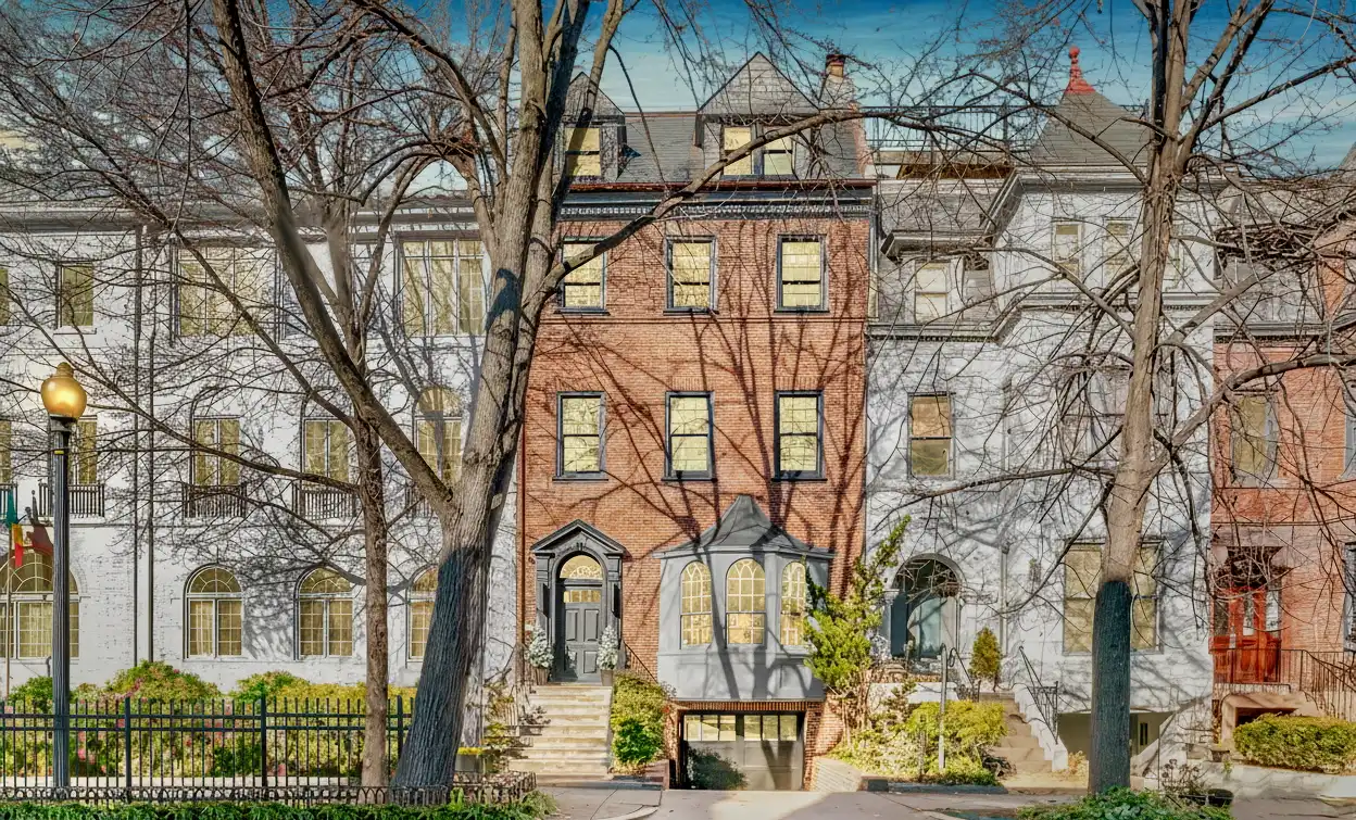 Image looking up at a red brick row home in Washington, DC